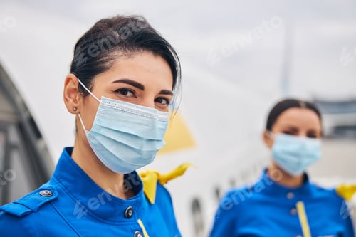 Preview: Two stewardesses dressed in uniforms standing outside