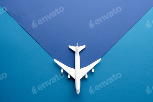 Preview: Close up of white airplane model on blue background with copy space
