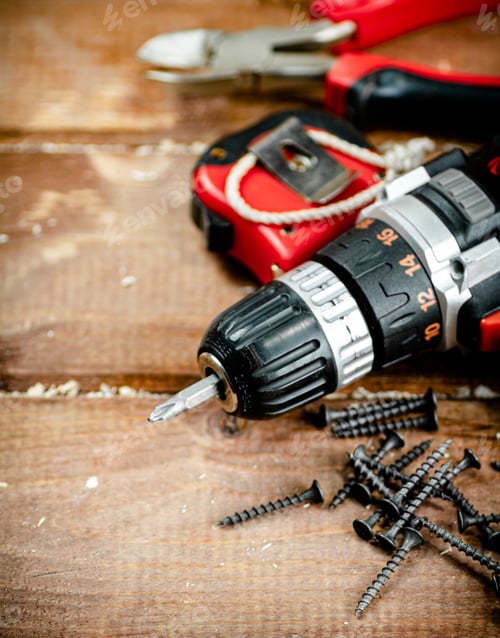 Preview: Power Drill and Screws on Wooden Background