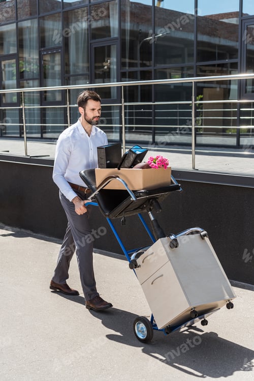 Preview: fired young manager with boxes on trolley cart