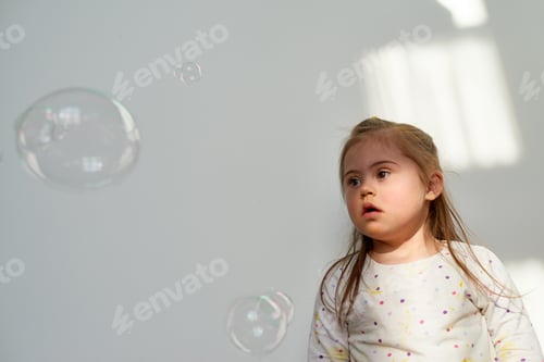 Preview: Girl Enjoys Playing with Bubbles at Home