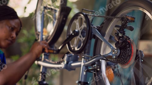 Preview: Skillful woman mending bicycle crank arm