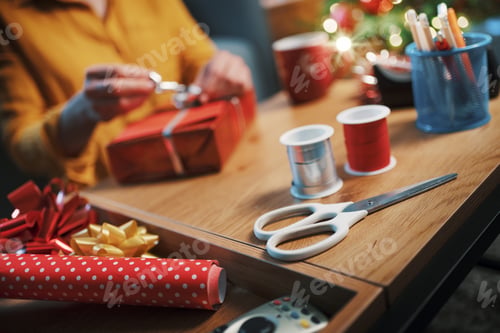 Preview: Woman preparing Christmas gifts at home