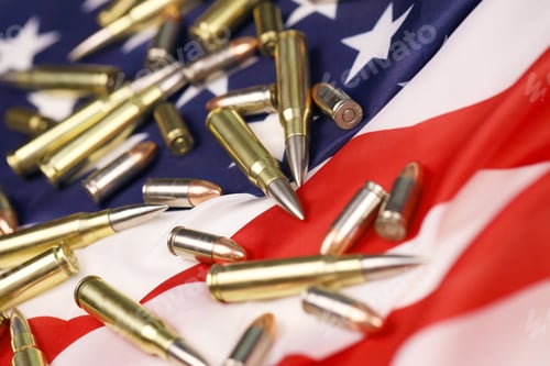 Preview: Many yellow 9mm and 5.56mm bullets and cartridges on United States flag