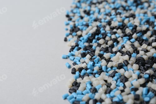 Preview: Pile of colorful plastic granules on grey background, closeup. Space for text