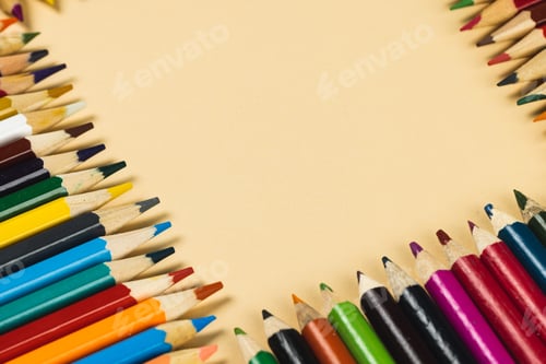 Preview: Composition of colorful crayons on beige surface with copy space