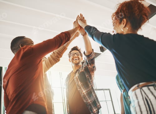 Preview: Collaborate then innovate. Shot of creative employees giving each other a high-five in the office.