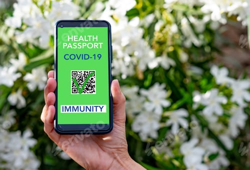 Preview: Human hand shows digital green card health passport for people vaccinated of coronavirus covid-19
