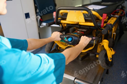 Preview: Doctor is taking a stretcher out of an ambulance auto
