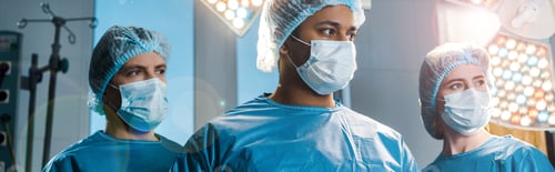 Preview: panoramic shot of doctors and nurse in uniforms and medical masks looking away