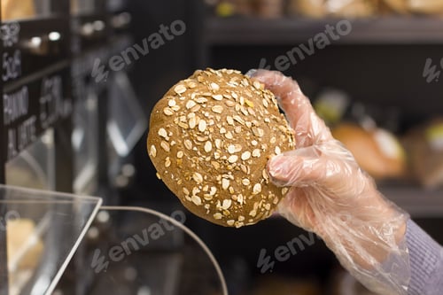 Preview: Female Hand Choosing Bread In The Market