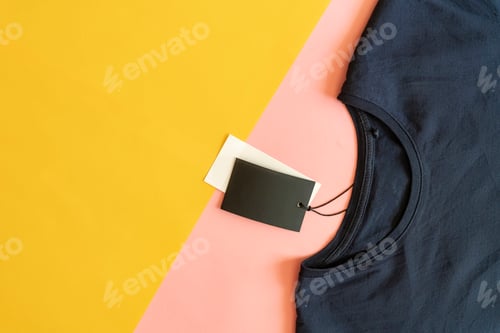 Preview: new casual t-shirt with sale price tag with copy space isolated on pink and yellow background f