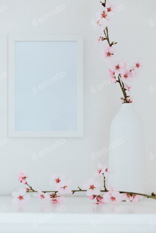 Preview: Almond blossom twigs with picture frame mockup. White background, copy space.