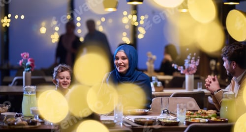 Preview: In a modern restaurant, an Islamic couple and their children joyfully await their iftar meal during