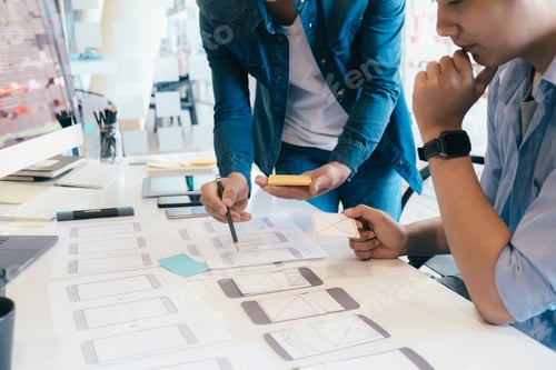 Preview: Software developer and UX UI designer are designing mobile application.