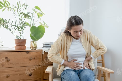 Preview: woman hand touching abdomen having stomach ache,