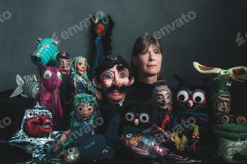 Preview: Studio Portrait Of Puppeteer Standing Between Handmade Puppets.