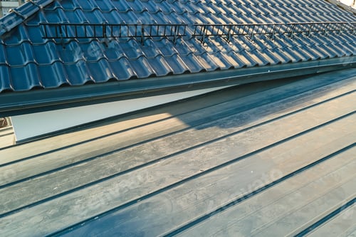 Preview: Closeup snow guard for safety in winter on house roof top covered with ceramic shingles