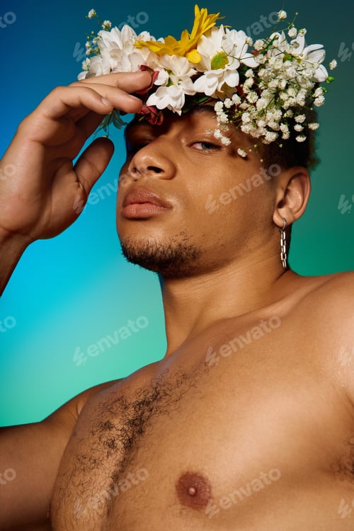 Preview: Young African American man with flowers in hair poses in a vibrant studio setting