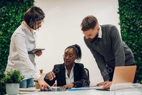 Preview: Multicultural team working together in office and having a meeting