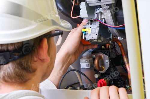 Preview: Technician servicing or Repair of a gas boiler, setting up and servicing. gas boiler for heating