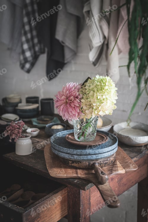 Preview: Table with set of flowers in glasses in room