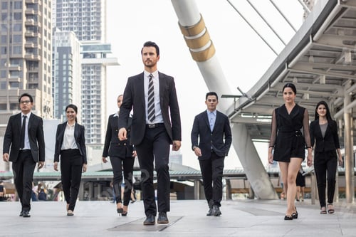 Preview: businesspeople team of multi ethnic walking with confidence in full suit