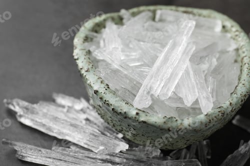 Preview: Menthol crystals in bowl on grey background, closeup