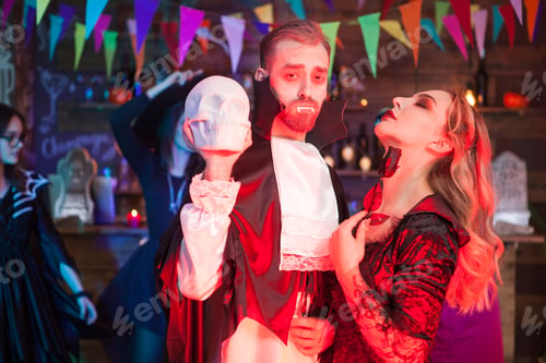 Preview: Beautiful couple dressed up like Dracula and a sexy witch for halloween party