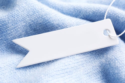 Preview: Tag with space for text on light blue knitted fabric, top view