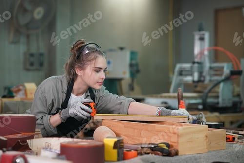 Preview: Small business of a young woman in furniture workshop background.
