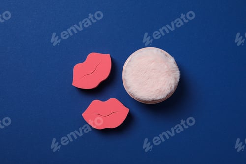 Preview: Cosmetic sponges and powder on blue background, top view
