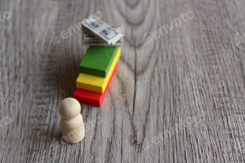 Preview: Wooden doll and stack of money on top of staircase