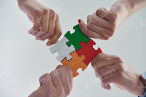 Preview: Group Of Business People Assembling Jigsaw Puzzle And Represent Team Support And Help Concept