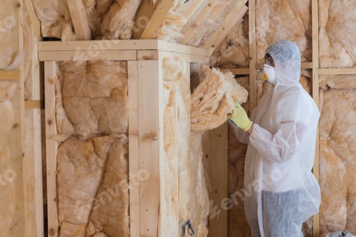 Preview: Worker Filling Walls With Insulation Material In Construction Site