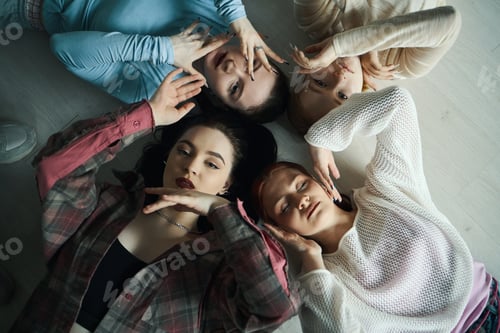 Preview: Stylish Young Women Relaxing Together on Floor
