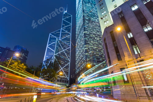 Preview: Urban nightscape with traffic light trails and modern skyscrapers
