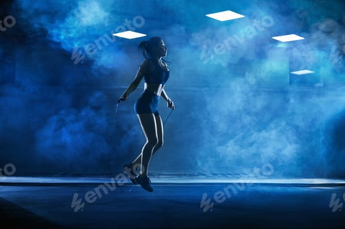 Preview: Athletic woman using skipping rope