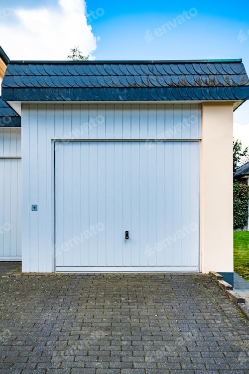 Preview: wide garage door and concrete driveway in front