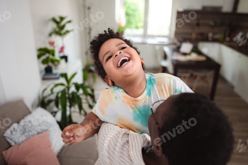 Preview: Black father and son laughing having fun at home