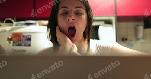 Preview: Young Woman Yawning In Front Of Computer Screen