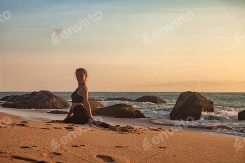 Preview: Perfect young woman doing splits pose, does yoga workout on sea beach