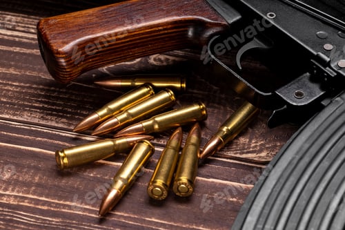 Preview: Bullets and Kalashnikov assault rifle on wooden background