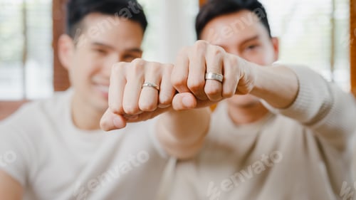Preview: Portrait Young Asia Gay couple feeling happy showing ring at home.
