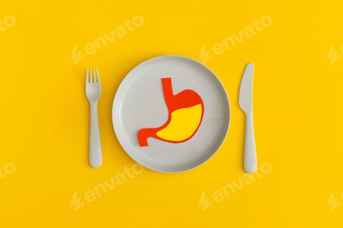 Preview: Blue plate with fork and spoon on a yellow background. Top view. Flat lay.