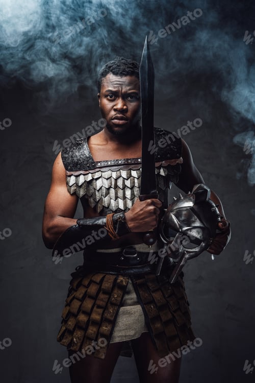 Preview: Studio shot of fearful authentic gladiator of african descent with gladius