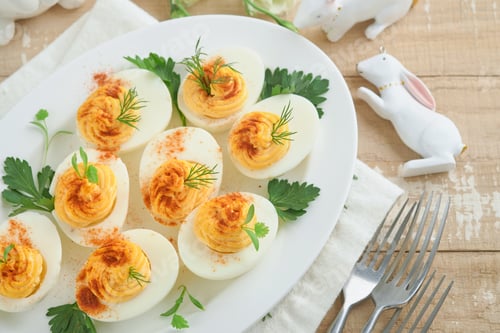 Preview: Easter stuffed eggs. Traditional Easter brunch or dinner with stuffed eggs with paprika, carrot cake