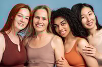 Preview: Four diverse, multinational women embracing, looking at camera, closeup posing in studio