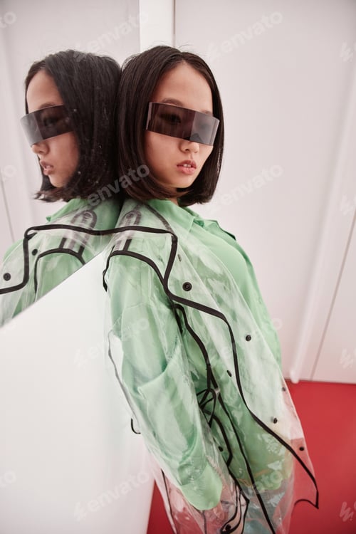 Preview: Young Asian Woman Wearing Plastic Coat in Futuristic Set