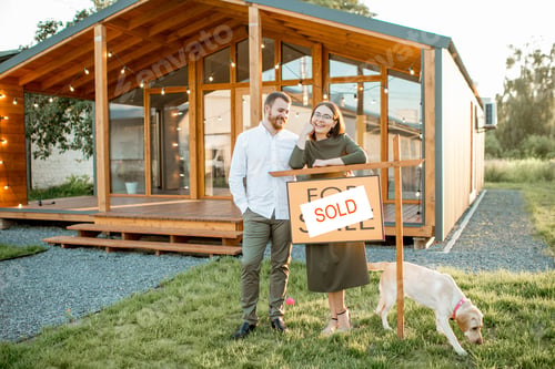 Preview: Couple in front of their new house